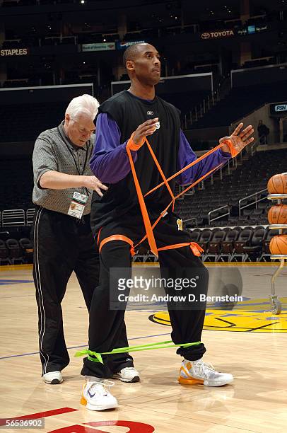 Kobe Bryant of the Los Angeles Lakers warmups up with strength coach Alex McKechnie before the game against the Philadelphia 76ers on January 6, 2006...