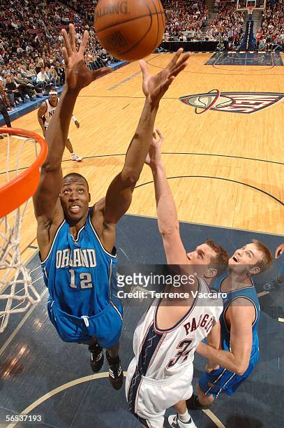 Dwight Howard of the Orlando Magic rebounds over Scott Padgett of the New Jersey Nets on January 6, 2006 at the Continental Airlines Arena in East...