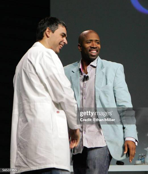 Google co-founder Larry Page talks with former NBA player Kenny Smith during Page's keynote address at the International Consumer Electronics Show...