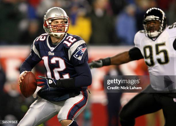 Quarterback Tom Brady of the New England Patriots drops back to pass as Paul Spicer of the Jacksonville Jaguars gives chase during their AFC Wildcard...