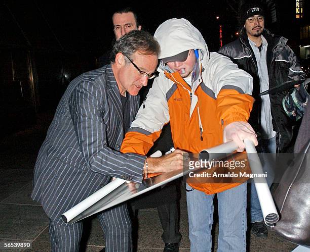 Robin Williams signs autographs as he arrives at the 60th birthday party for Jann Wenner, editor and publisher of Rolling Stone magazine, on January...