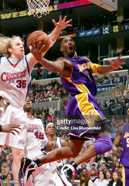 Kobe Bryant of the Los Angeles Lakers puts a shot up against Chris Kaman of the Los Angeles Clippers on January 7, 2006 at Staples Center in Los...