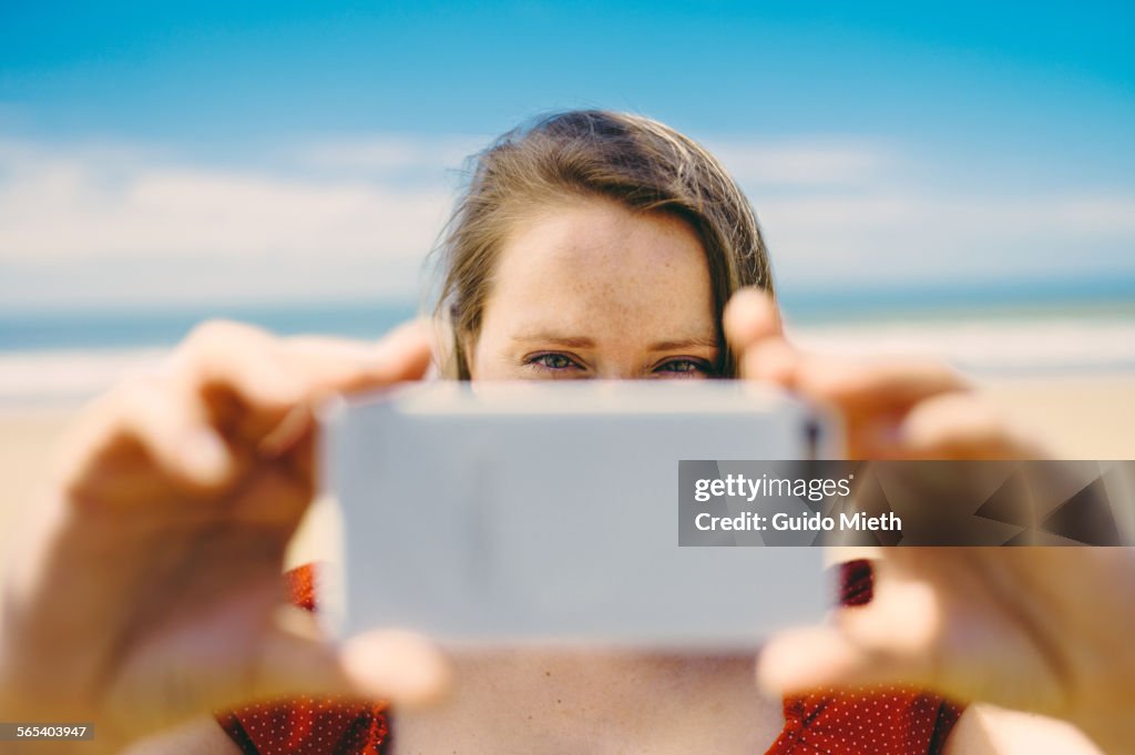 Woman taking pictures with smartphone.