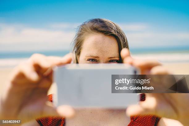 woman taking pictures with smartphone. - longeville sur mer stock pictures, royalty-free photos & images