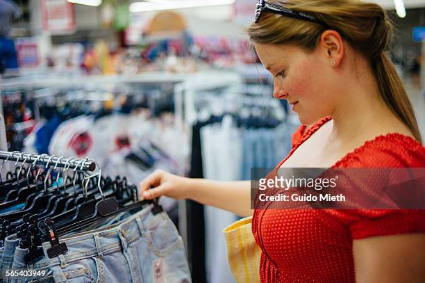 woman looking at supermarket offer - longeville sur mer stock pictures, royalty-free photos & images