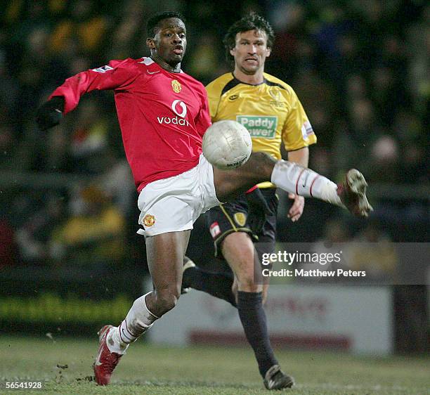 Louis Saha of Manchester United clashes with Darren Tinson of Burton Albion during the FA Cup Third Round match between Burton Albion and Manchester...