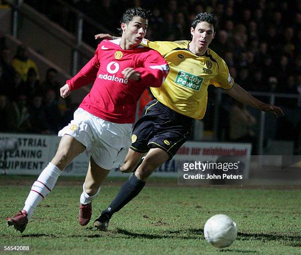 Cristiano Ronaldo of Manchester United clashes with Andrew Corbett of Burton Albion during the FA Cup Third Round match between Burton Albion and...