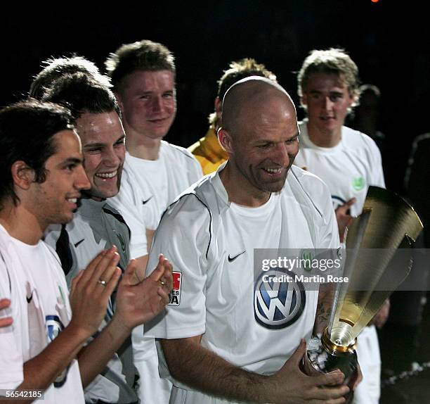 Stefan Schnoor of Wolfsburg presents the trophy to his team mates after winning the HSV Indoor Cup first place match between Hertha BSC Berlin and...