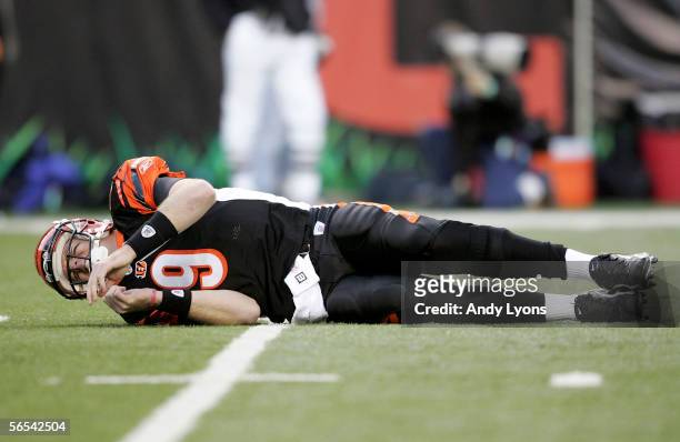 Quarterback Carson Palmer of the Cincinnati Bengals lies on the ground in pain after a hit to his knee on the first drive of the AFC Wild Card...