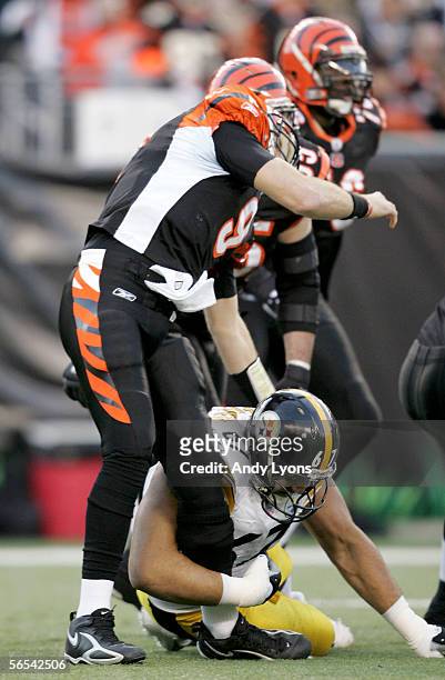 Quarterback Carson Palmer of the Cincinnati Bengals is hit in the knee by Kimo von Oelhoffen of the Pittsburgh Steelers on the first drive of the AFC...