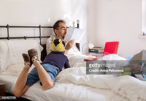 father and son reading manual of new toy - paper crown stock pictures, royalty-free photos & images