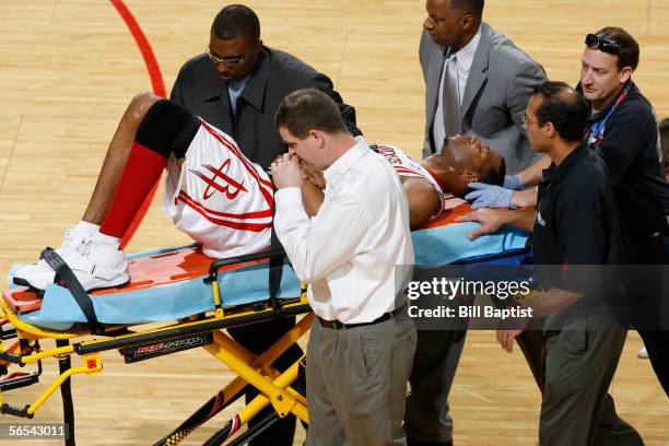 Tracy McGrady of the Houston Rockets leaves the court on a stretcher on his way to a local hospital after suffering a back injury at the end of the...