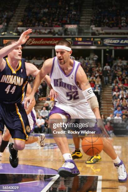 Brad Miller of the Sacramento Kings drives to the basket around Austin Croshere of the Indiana Pacers at the ARCO Arena on January 8, 2006 in...