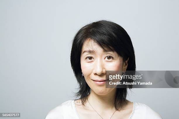 portrait of middle aged woman,smiling - content japanese ethnicity stock pictures, royalty-free photos & images