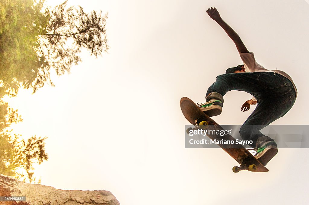 Teenage Boy Performing Stunt on Skateboard