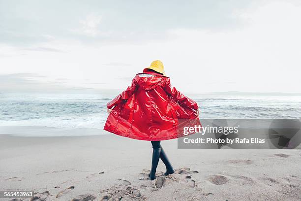 woman in raincoat on the beach - parka stock pictures, royalty-free photos & images