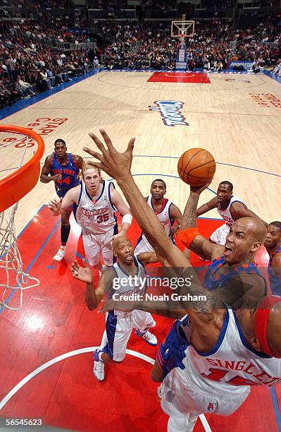 Stephon Marbury of the New York Knicks takes the ball to the basket against James Singleton of the Los Angeles Clippers during the game on December...