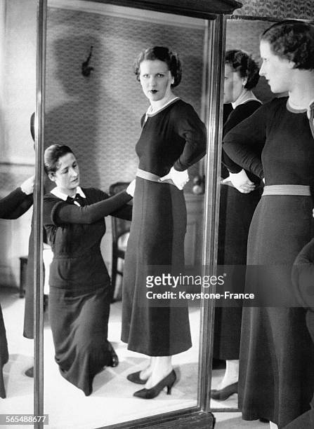 Jeune femme essayant une robe chez une couturière, circa 1930.