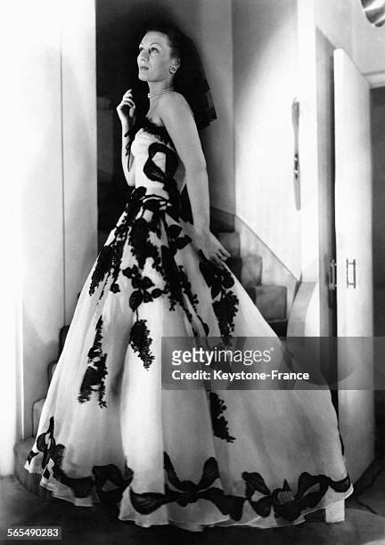 Robe 'Apothéose' en organdi blanc avec incrustation de chantilly noir, à Paris, France, le 17 mars 1948.
