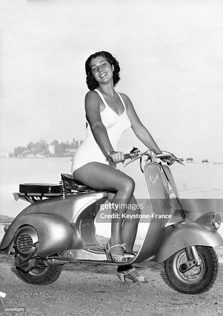 Jeune femme en maillot de bain sur une Vespa