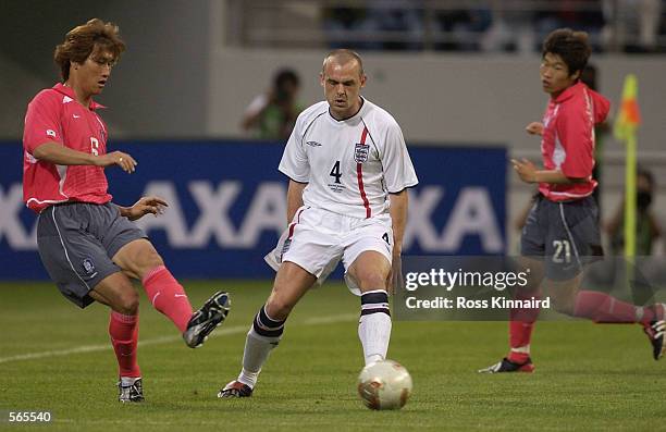 Danny Murphy of England is challenged by Yoo Sang-Chul of Korea during the friendly international match between Korea and England at the Seogwipo...