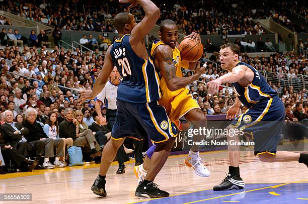 Kobe Bryant of the Los Angeles Lakers drives to the hoop against Fred Jones and Sarunas Jasikevicius of the Indiana Pacers on January 9, 2006 at...