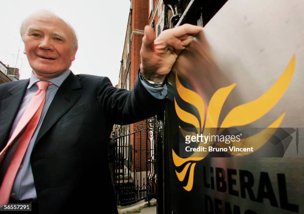 Temporary leader of the Liberal Democrats, Menzies Campbell poses next to the Party's logo outside their headquarters on January 10, 2006 in London....