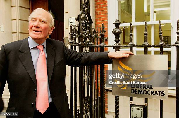 Temporary leader of the Liberal Democrats, Menzies Campbell poses next to the Party's logo outside their headquarters on January 10, 2006 in London....