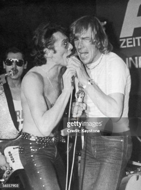 English racing driver James Hunt helps out the band at the 'Speedman of the Year' party at the Eastside Disco in Munich, December 1978.