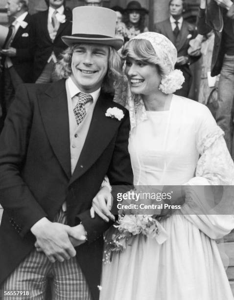 English racing driver James Hunt with Suzy Miller after their wedding at Brompton Oratory, London, 19th October 1974.