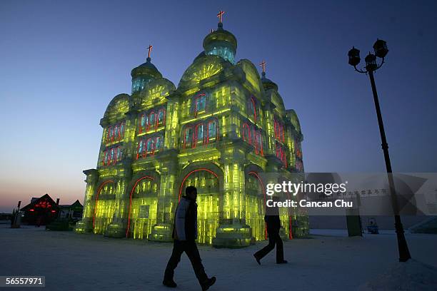 Tourists visit the ice buildings on display at the Grand Ice and Snow World, part of the 22nd Harbin International Ice and Snow Festival on January...