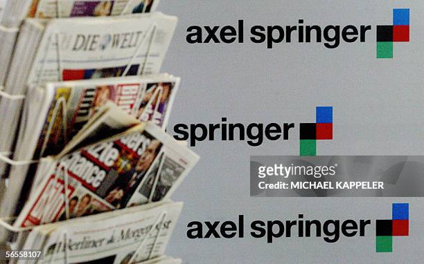 Picture taken on 13 March 2003 in Berlin shows a news rack standing in front a wall displaying the logo of German newspaper publisher Axel Springer....