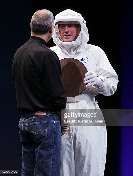 Intel CEO Paul Otellini wears a clean suit as he shows an Intel chip to Apple CEO Steve Jobs during his keynote address at the 2006 Macworld January...