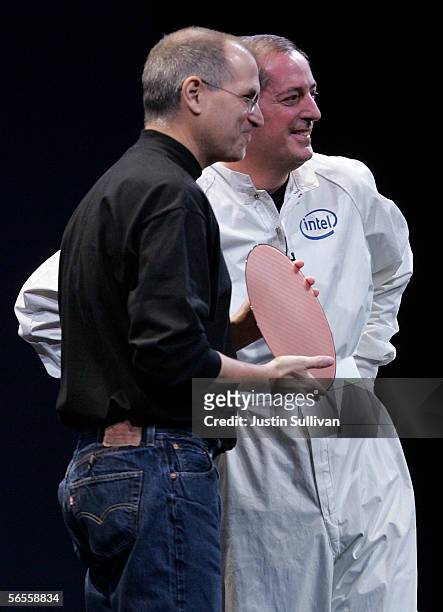 Intel CEO Paul Otellini wears a clean suit as he shows an Intel chip to Apple CEO Steve Jobs during his keynote address the 2006 Macworld January 10,...