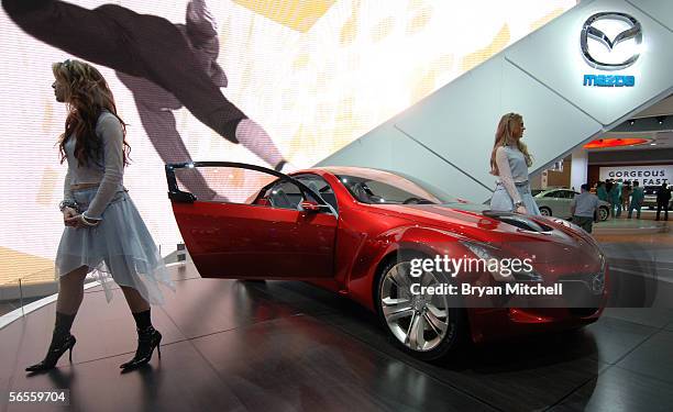 Models Fallon Jamil and Krystle Wilson pose with the Mazda Kabura Concept car on the final press preview day at the North American International Auto...