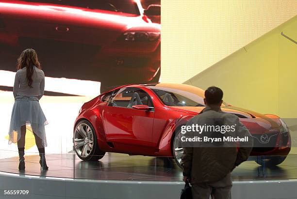 Model Fallon Jamil poses with the Mazda Kabura Concept car on the final press preview day at the North American International Auto show January 10,...