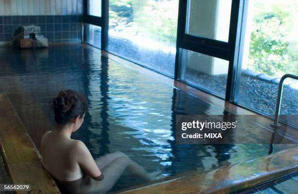 a young woman bathing in hot springs - hot japan women stock-fotos und bilder