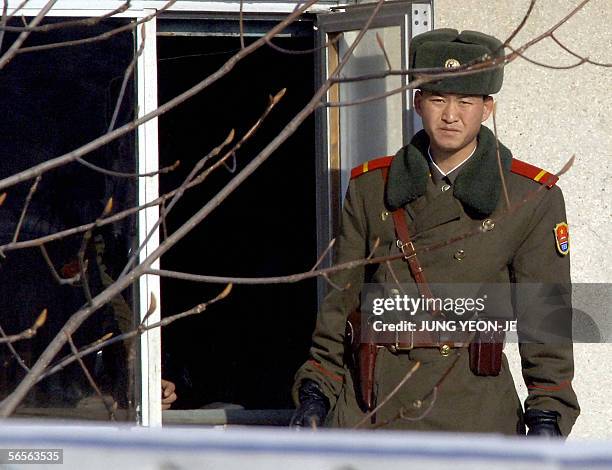 North Korean soldier looks towards the South side at the border village of Panmunjom, 11 January 2006, in the Demilitarized Zone dividing North and...