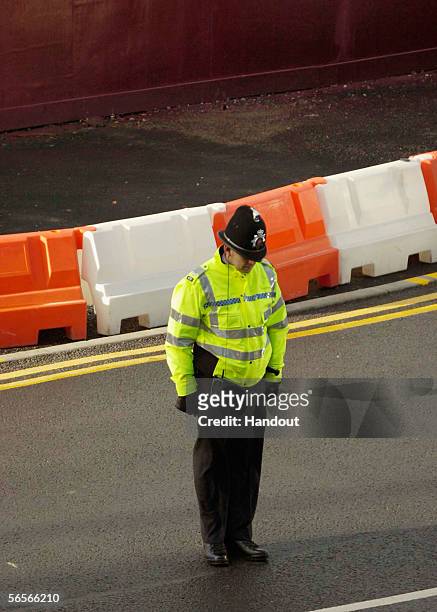 Police officer bows his head as the funeral cortege for Police Constable Sharon Beshenivsky arrives at Bradford Cathedral on January 11, 2006 in...