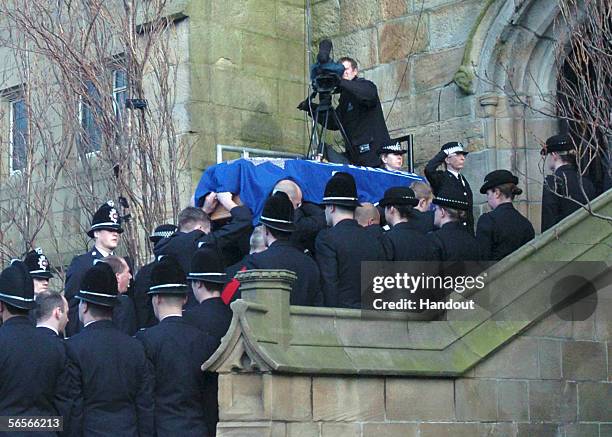 Police officers salute as the coffin of Police Constable Sharon Beshenivsky is carried into Bradford Cathedral on January 11, 2006 in Bradford,...