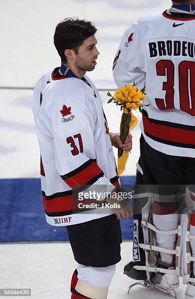 Canadian professional hockey player Michael Peca , center for the New York Islanders and member of Team Canada, stands near teammate Martin Brodeur,...