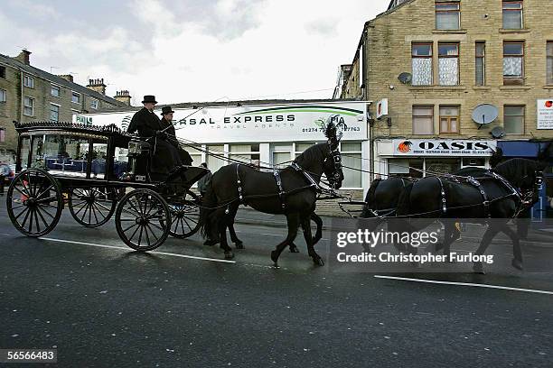 Police officers pay their respects to the funeral cortege of Police Constable Sharon Beshenivsky as it passes the scene of her murder in Morley...