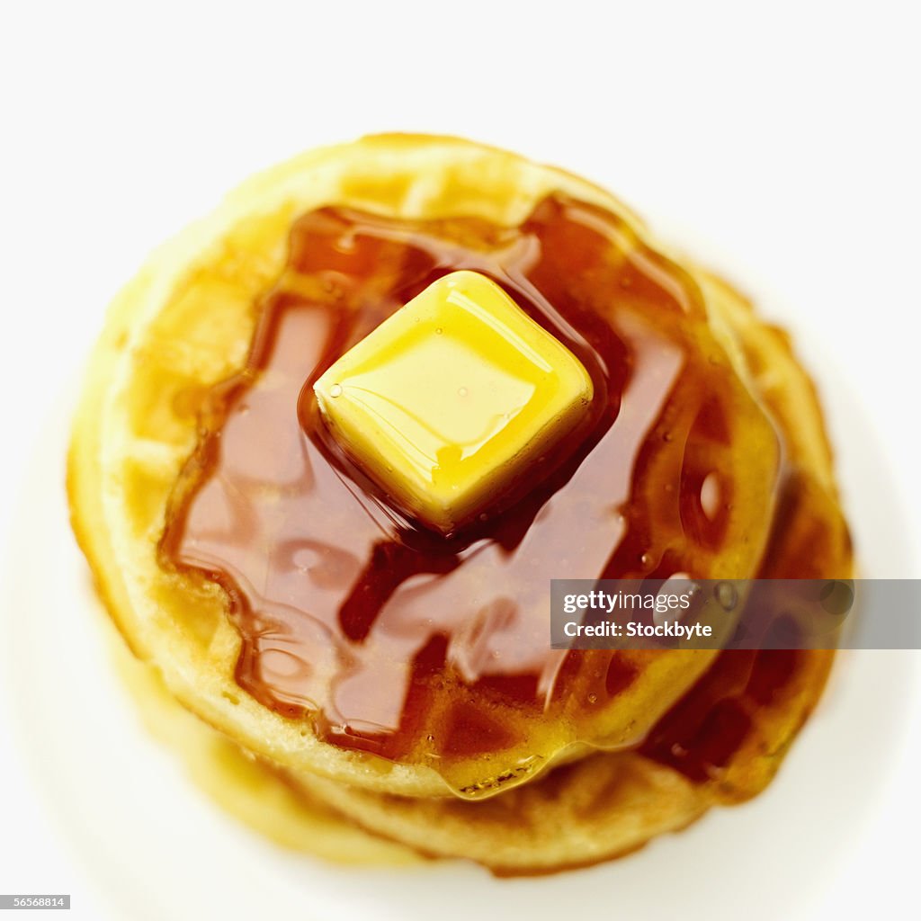 High angle view of waffles served with syrup and butter