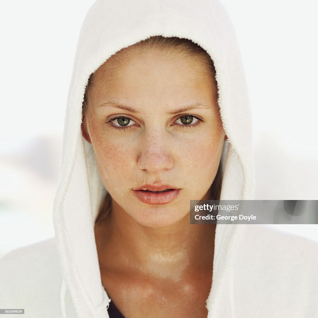 Portrait of a young woman wearing a hooded bathrobe