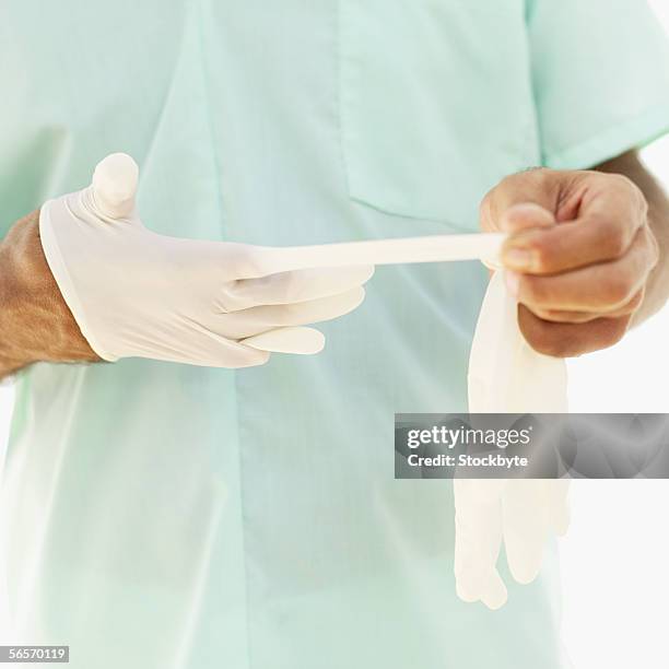 Removing Hand Surgeon Taking Off Gloves Photos and Premium High Res Pictures - Getty ...