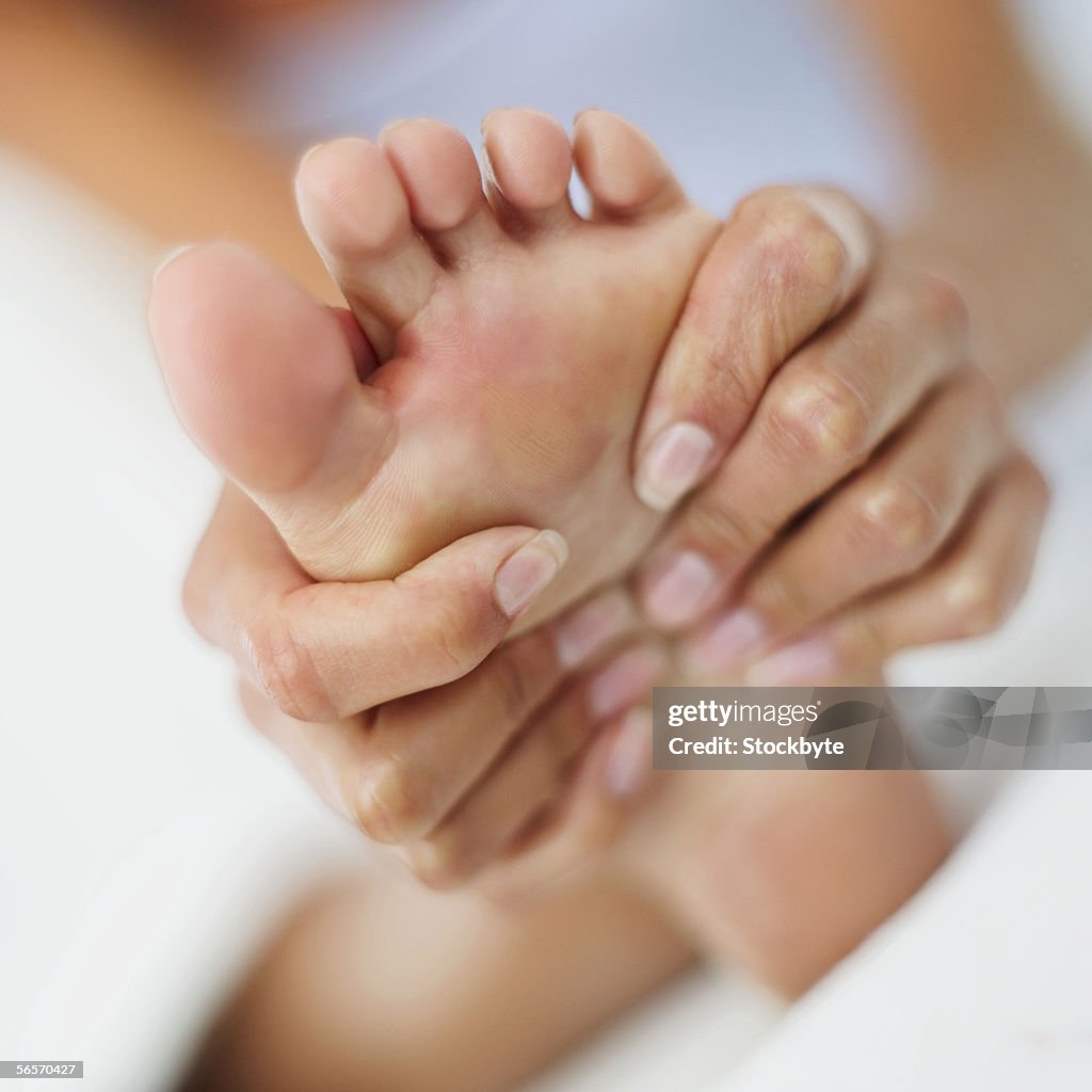 Woman massaging her foot