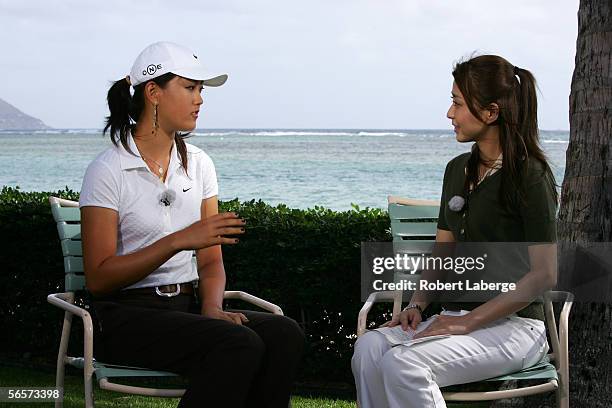 Michelle Wie speaks with show host Mao Kobayashi during an interview for Fuji Television at the Sony Open at the Waialae Country Club on January 11,...