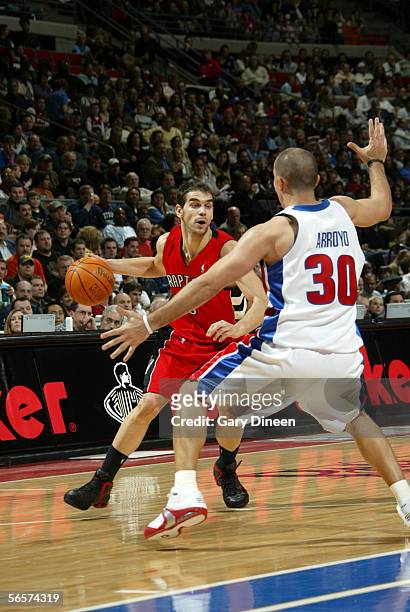 Jose Calderon of the Toronto Raptors moves the ball against Carlos Arroyo of the Detroit Pistons December 27 2005 at the Palace of Auburn Hills in...