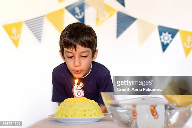 young boy blowing out birthday candles - number candles stock pictures, royalty-free photos & images