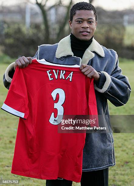 New signing Patrice Evra poses with a shirt ahead of the press conference to announce the signing of Patrice Evra at Carrington Training Ground on...